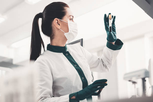 istock Profile of concentrated doctor with blood sample 989375870