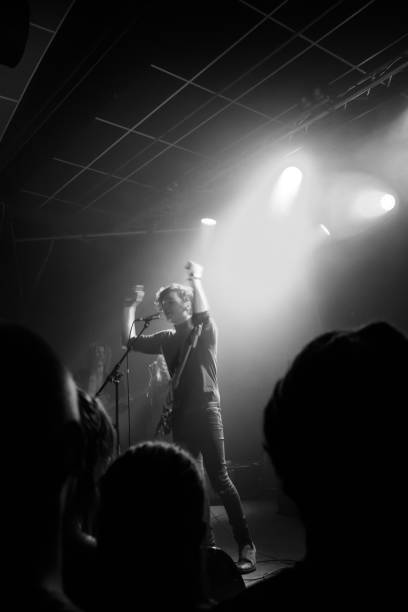 istock Yonung rock band in action on stage 989375886
