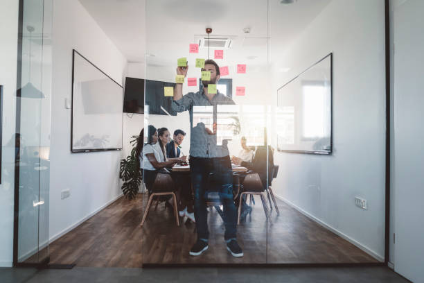 istock Young entrepreneur having a meeting with his team-mates 989395968