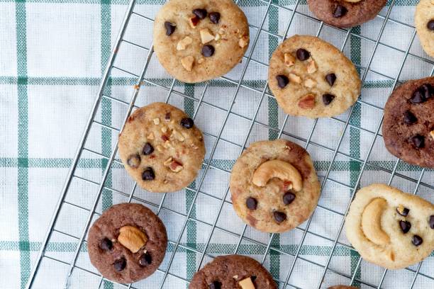 istock Delicious Chocolate Chip Cookies on cooling rack and on checkered tablecloth, Top view 989397706