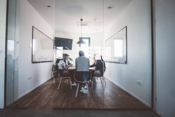 istock Light loft office and young businesspeople 989402726
