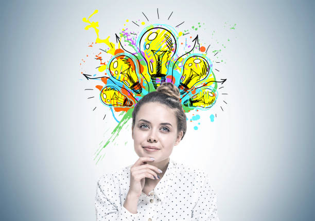 istock Smiling young woman dreaming, good idea 989403788