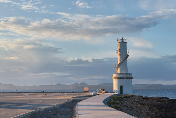The lighthouse of La Savina in the port of Formentera Island at sunset. Balearic Islands. Spain