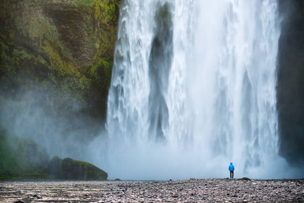 istock Tourist near Skogafoss waterfall in Iceland 989409920
