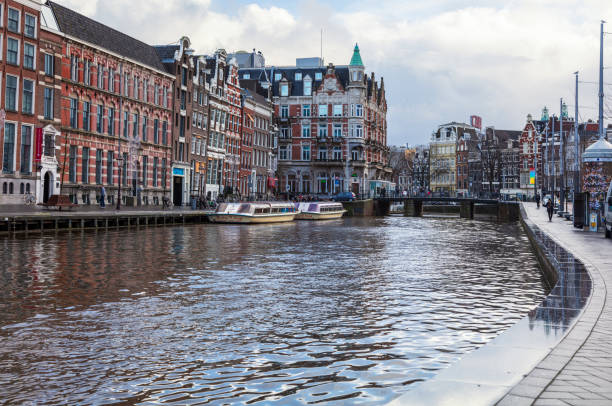 Amsterdam, Netherlands - December 14, 2017:  Typical Dutch houses built by the canal, Amsterdam, Netherlands