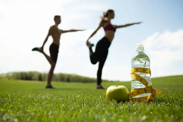 Photo of Man and woman are training in green park