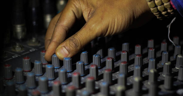 istock hands operating knobs of light and sound board console at a concert theater 989415714