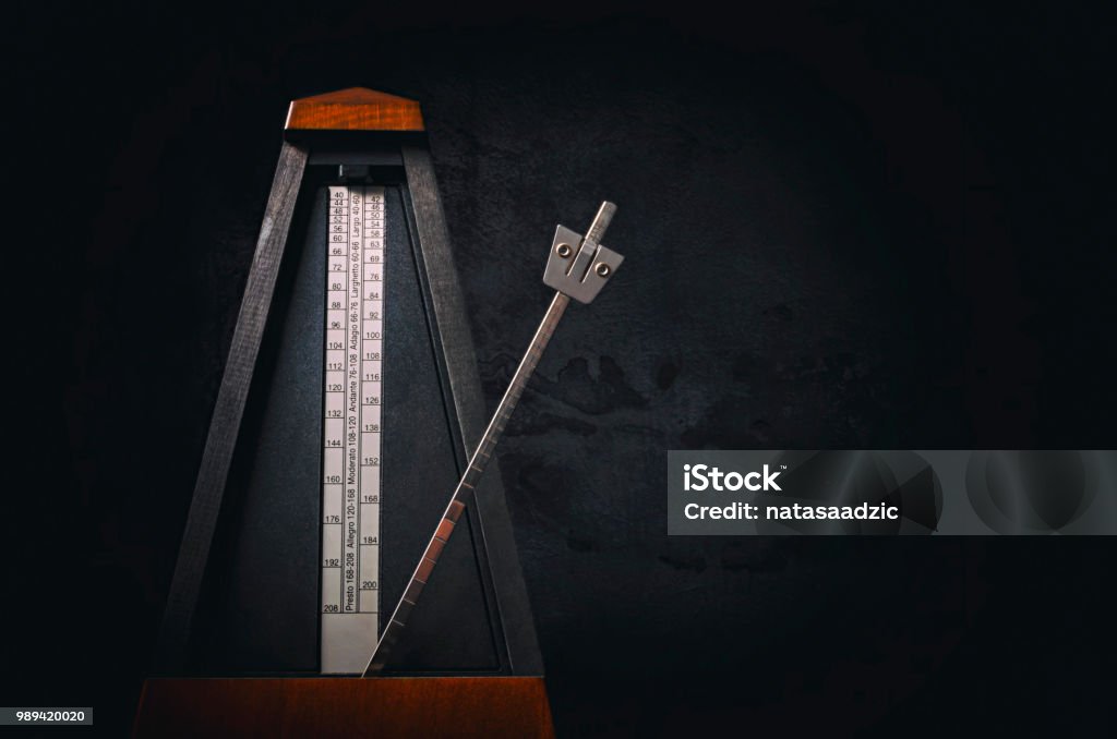 Metronome Vintage metronome on dark background. Low key image. Metronome Stock Photo