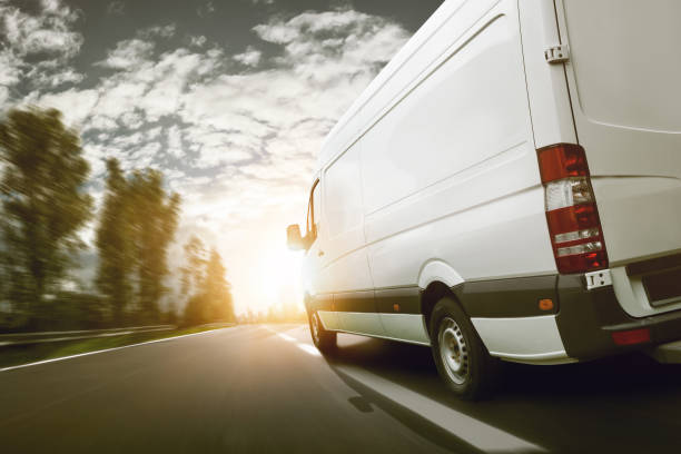 istock delivery trucks at sunset 989429324
