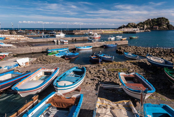 istock Small port in Aci Trezza (Sicily, Italy); the island Lachea in the background 989429358
