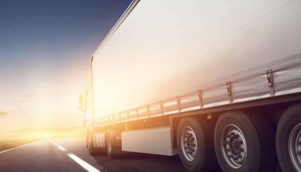 istock Truck on the road at sunset 989430070