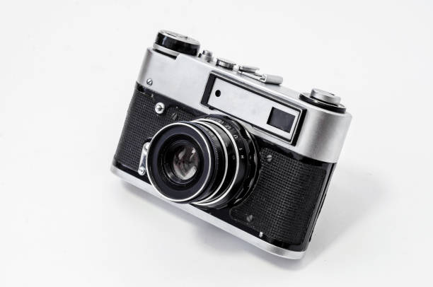 istock Vintage film camera, close-up on a white background, side view 989430590