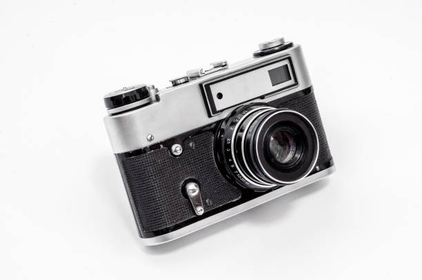istock Vintage film camera, close-up on a white background, side view 989430632