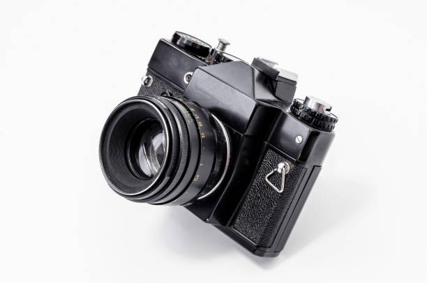 istock Vintage film camera, close-up on a white background, side view 989430874