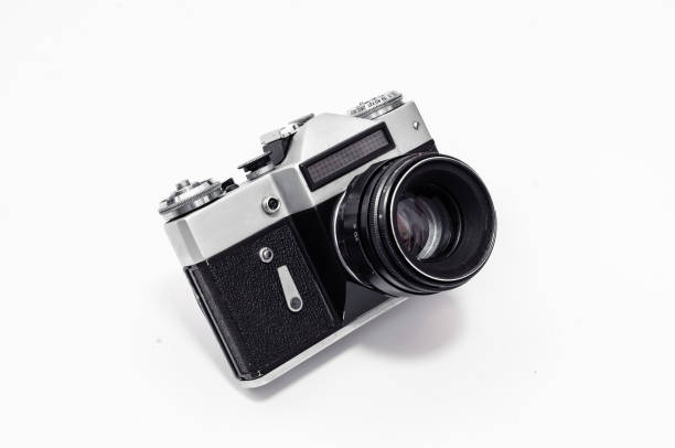 istock Vintage film camera, close-up on a white background, side view 989431146