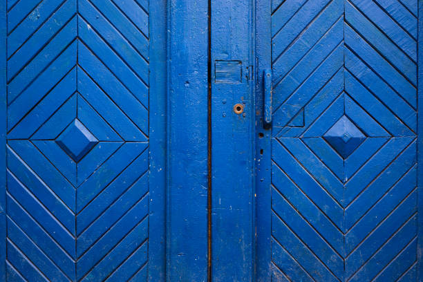 Fragment of an old wooden door. Background for a design of a saturated blue color