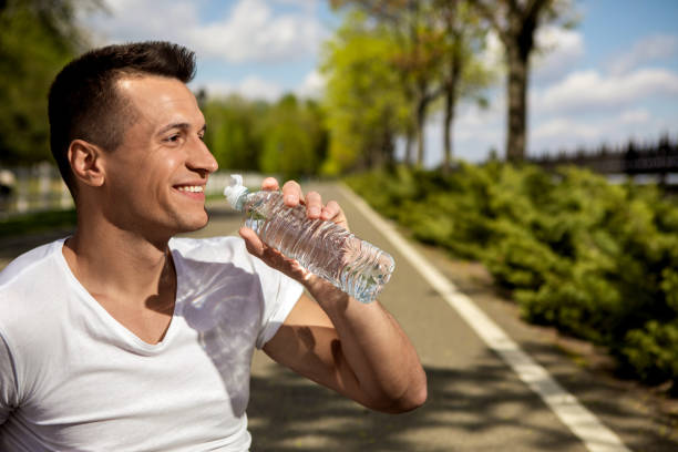 istock Happy man is quenching thirst outdoors 989440574