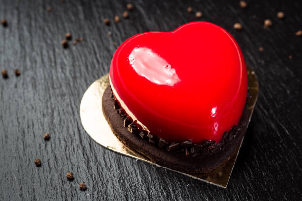 istock Heart shaped red velvet cake with chocolate 989446052