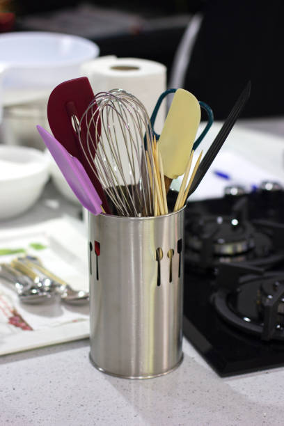 istock Ingredients and cooking utensils on table in a metal cup. 989461234