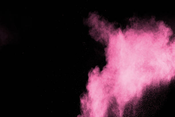 istock abstract pink dust explosion on  black background. abstract pink powder splattered on black background, Freeze motion of pink powder splash. 989468748