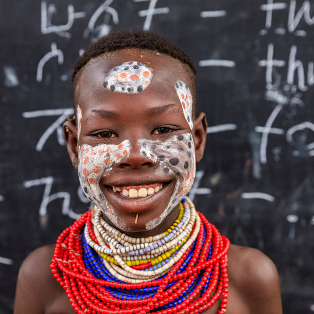 istock African young girl is learning  English language, Karo tribe 989474156