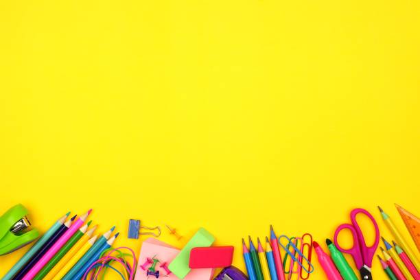 istock School supplies bottom border over a yellow background 989480160