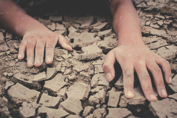 istock High Angle View Of Cropped Hands On Barren Ground 989491050
