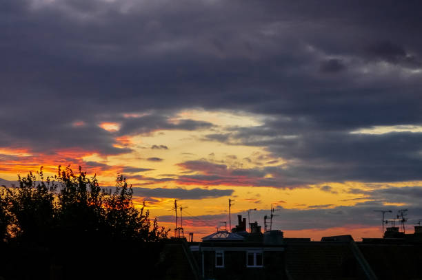 istock Dramatic Urban Sunset with clouds and Silhouette 989496158