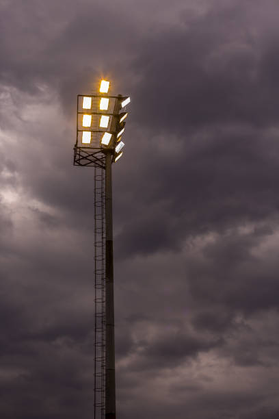 istock Bright sports stadium lights on a cloudy evening 989497650