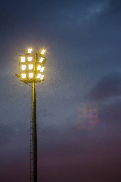 istock Bright sports stadium lights on a cloudy evening 989497688