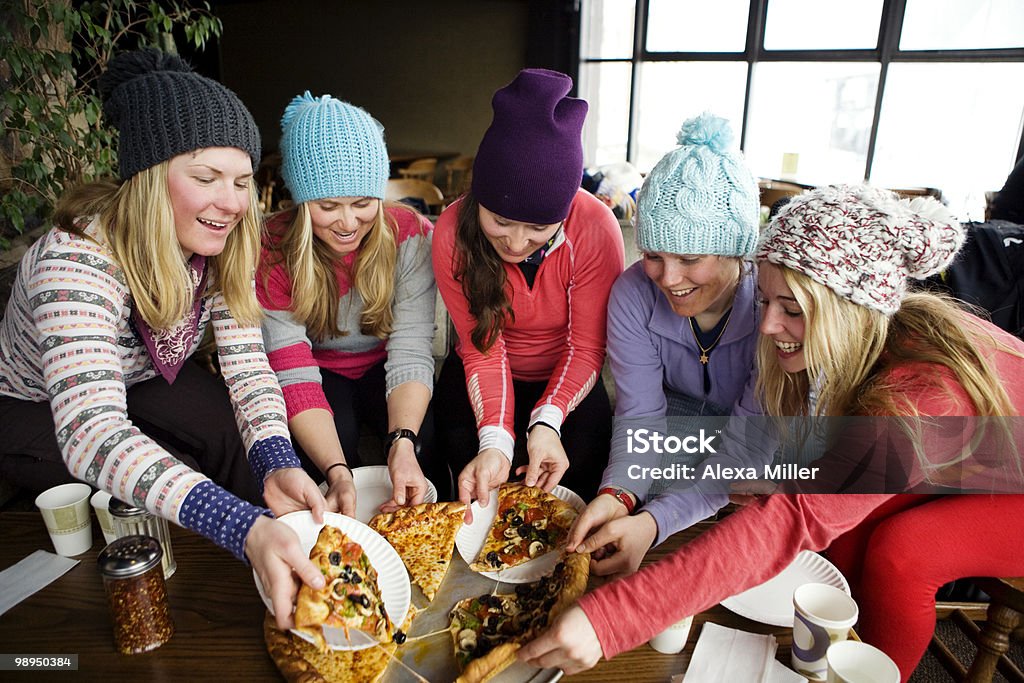 Girls sharing pizza. - Foto de stock de Pousada de esqui royalty-free