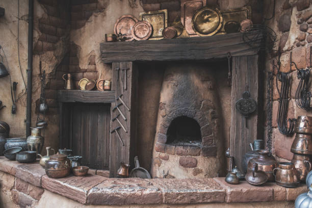 istock Old Antique Arabian brassware, pots, plates, decorations around a old kitchen with a coal-fired oven/fireplace. 989510588