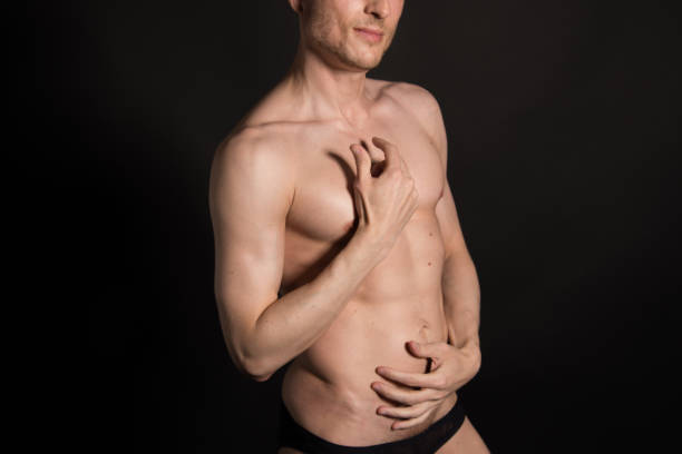 istock Sexy man without a shirt. Black background. 989510690