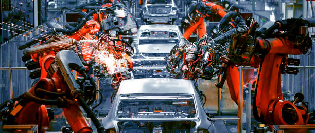in the industrial production workshop, the robot arm of the automobile production line is working - linha de produção imagens e fotografias de stock
