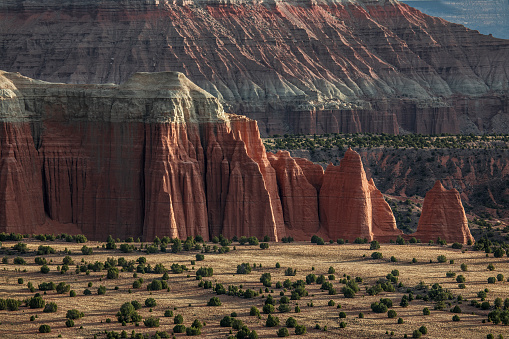 Light from a rising sun brightens Cathedral Valley at Capitol Reef National Park, Utah