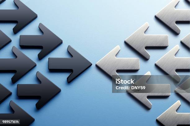 Arrows Pointing Toward A Confrontation Stock Photo - Download Image Now - Conflict, Confrontation, Concepts