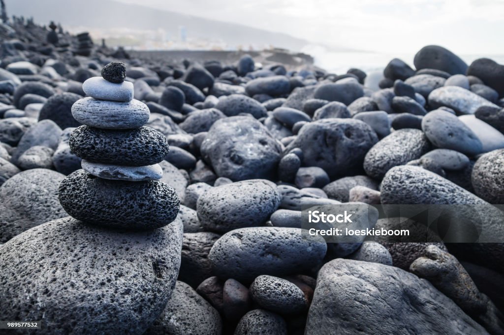 Pile of black lava stones at coastline at Puerto de la Cruz, Tenerife, Canary Islands, Spain Pile of different dark colour lava stones at coastline at Puerto de la Cruz, Tenerife, Canary Islands, Spain Atlantic Ocean Stock Photo