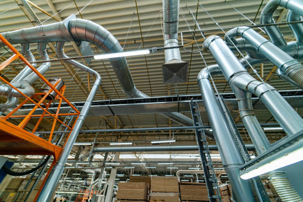 istock Industrial factory ceiling with ventilation system and lights 989586300