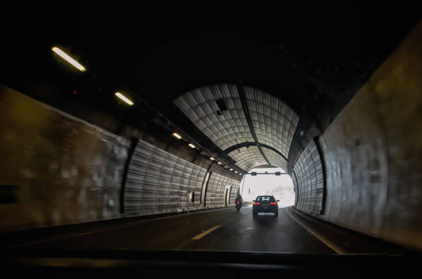 istock Car in motion, drawing through the dark tunnel 989609840