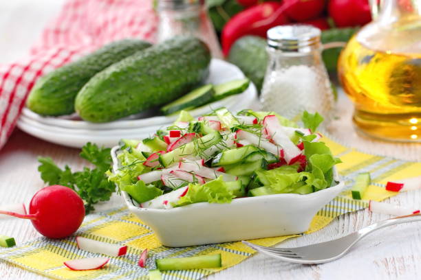 istock Fresh salad with radishes, cucumbers and olive oil 989610012