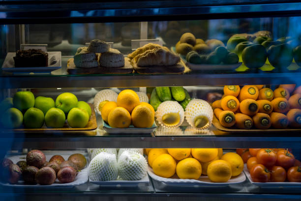 bäckerei und mix-früchte (orange, mango, karotte, rote beete, apfel, tomate, gurke) in glastür anzeigen kühlschrank im restaurant - refrigerator healthy eating mango fruit stock-fotos und bilder