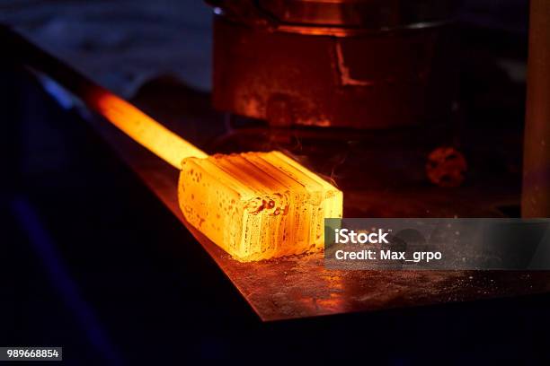 Glowing Iron Ingot On The Table Hot Metal Workpiece For The Manufacture Of Damascus Steel Stock Photo - Download Image Now