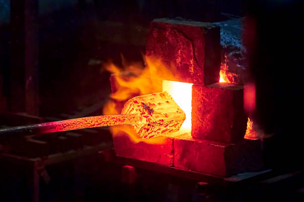 istock Burning  in a blacksmith forge.  Making metal items in smithy. In the smithy a red-hot iron piece in a hot fire flame is ready for further processing 989668920