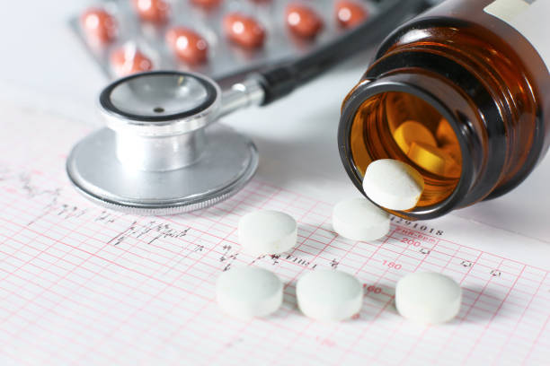 istock stethoscope, pills, vials in medical room on blue background top view mockup 989700512