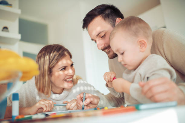 istock Cheerful young family having great time at home 989703142