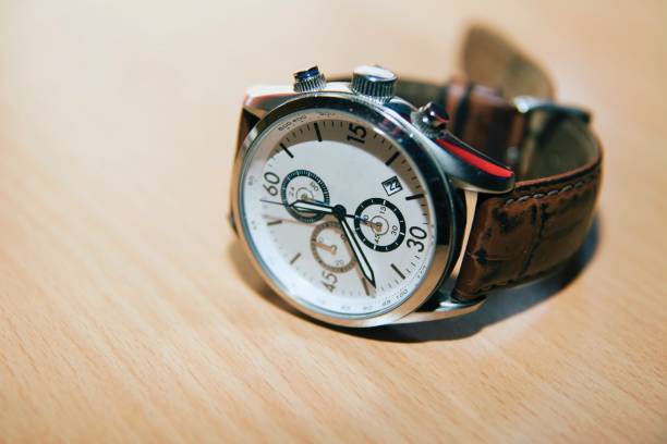 istock Mens Wristwatch on desk 989704112