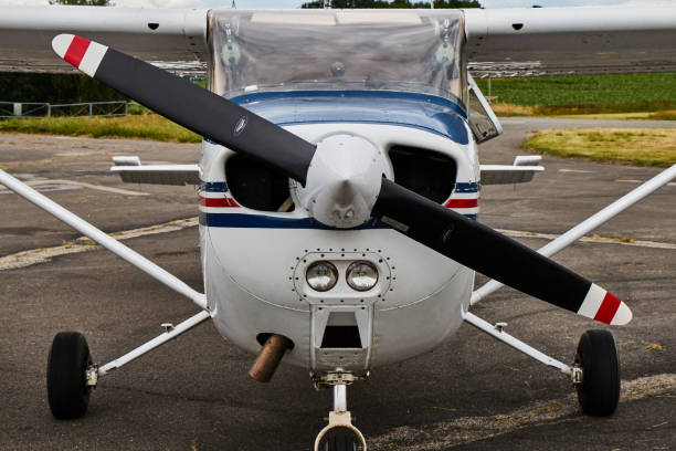 Front of a small airplane on a blue sky.