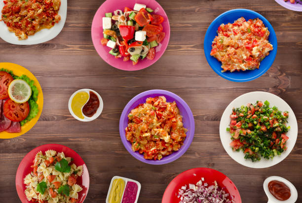 istock Pasta with vegetables and sauce on a table. Spaghetti on a plate. Mediterranean food. 989714348