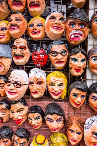 A tienda (market) selling polital and fun masks for an upcoming fiesta (New Year's Eve) in Cuenca, Ecuador Cuenca, Ecuador - Dec 30, 2012: A tienda (market) selling polital and fun masks for an upcoming fiesta (New Year's Eve) tienda stock pictures, royalty-free photos & images