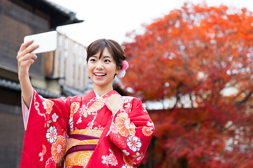 attractive asian woman wearing kimono in autumn